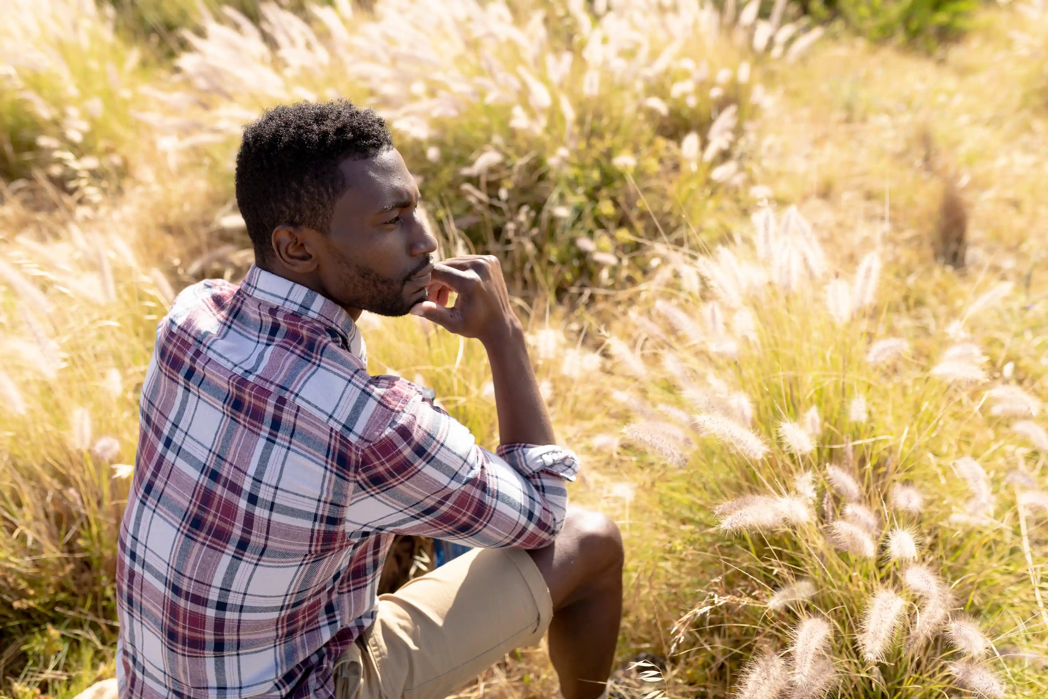 person sitting on a field contemplating