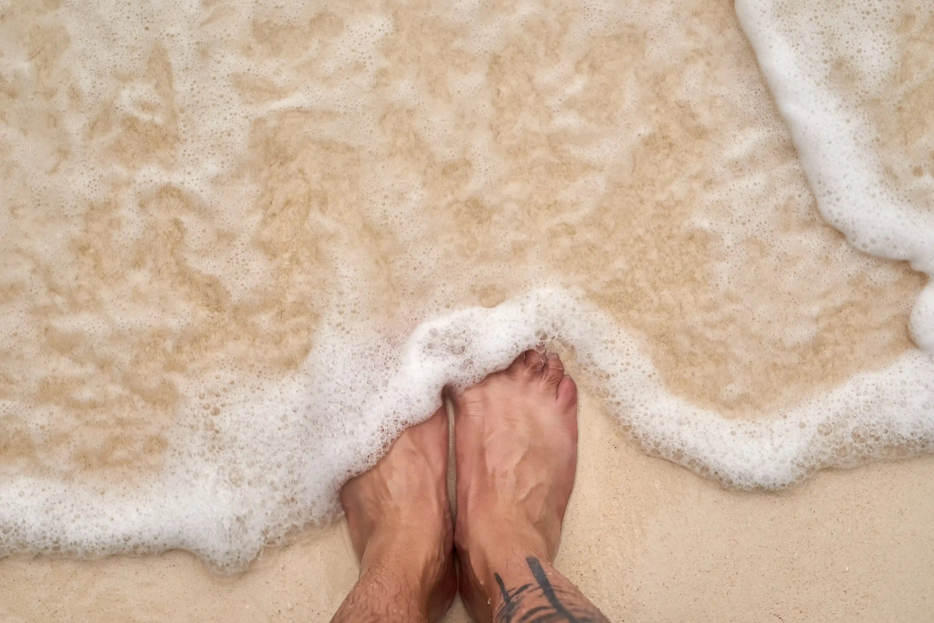 ocean water on feet indicating embodied mindfulness