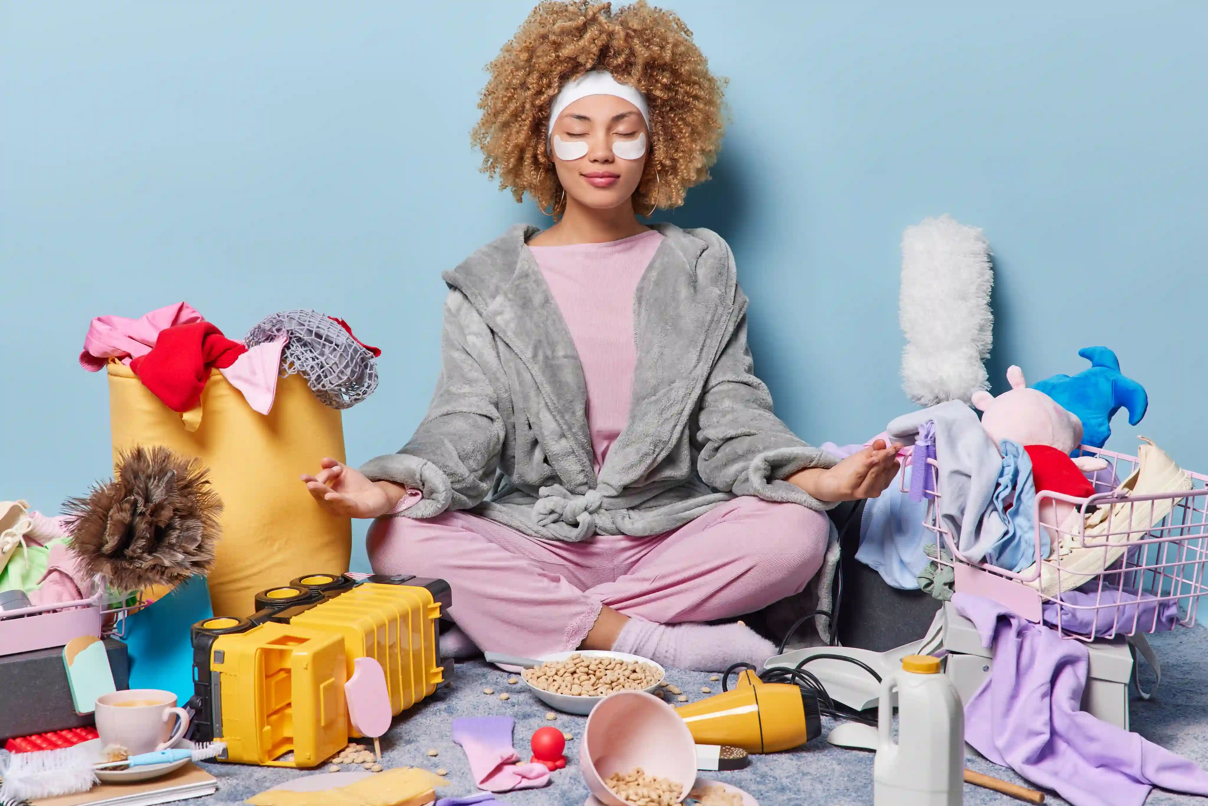 woman trying to meditate with a mess around her to indicate imperfect mindfulness is not perfect