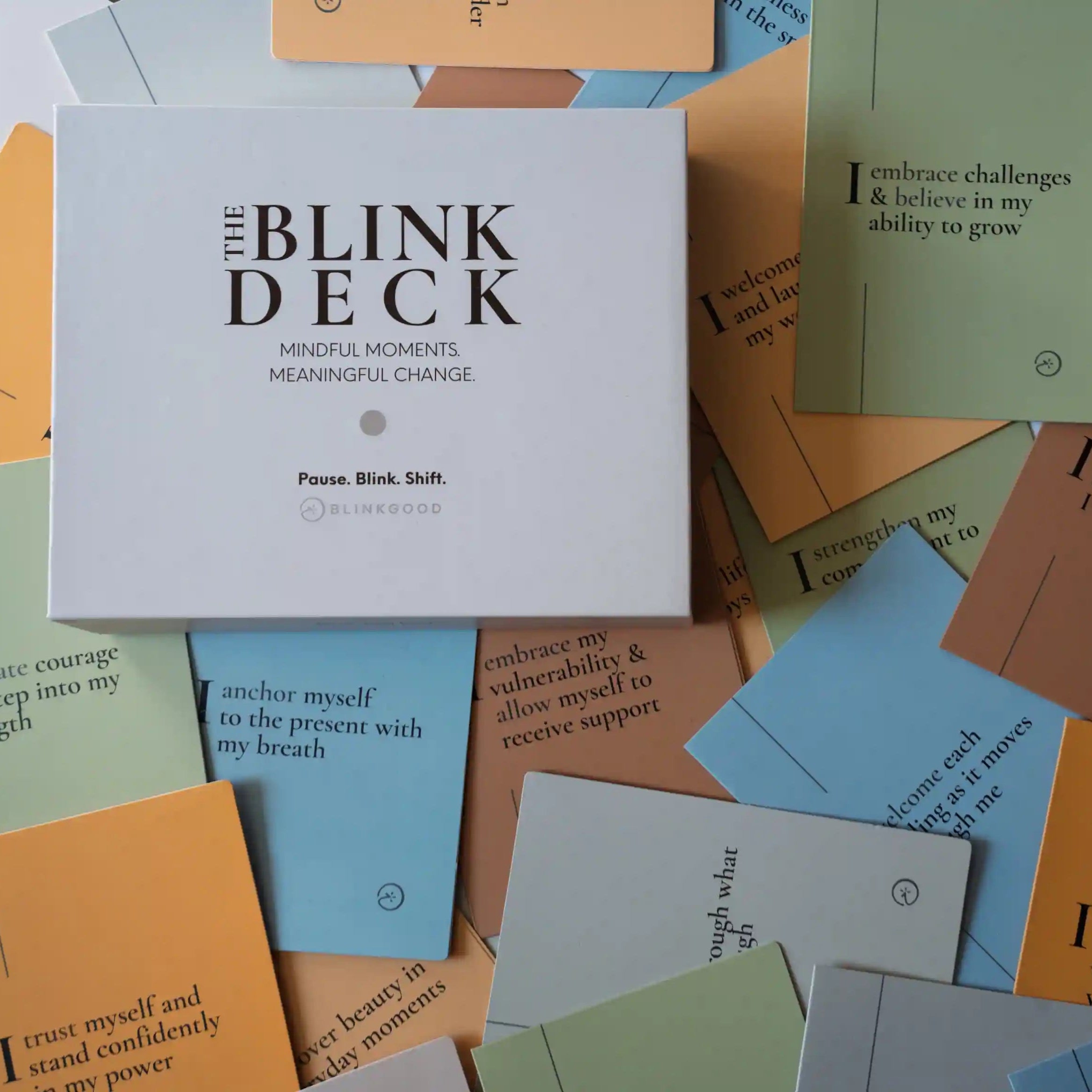 Collection of colorful cards with motivational phrases, featuring a box labeled 'The Blink Deck'.