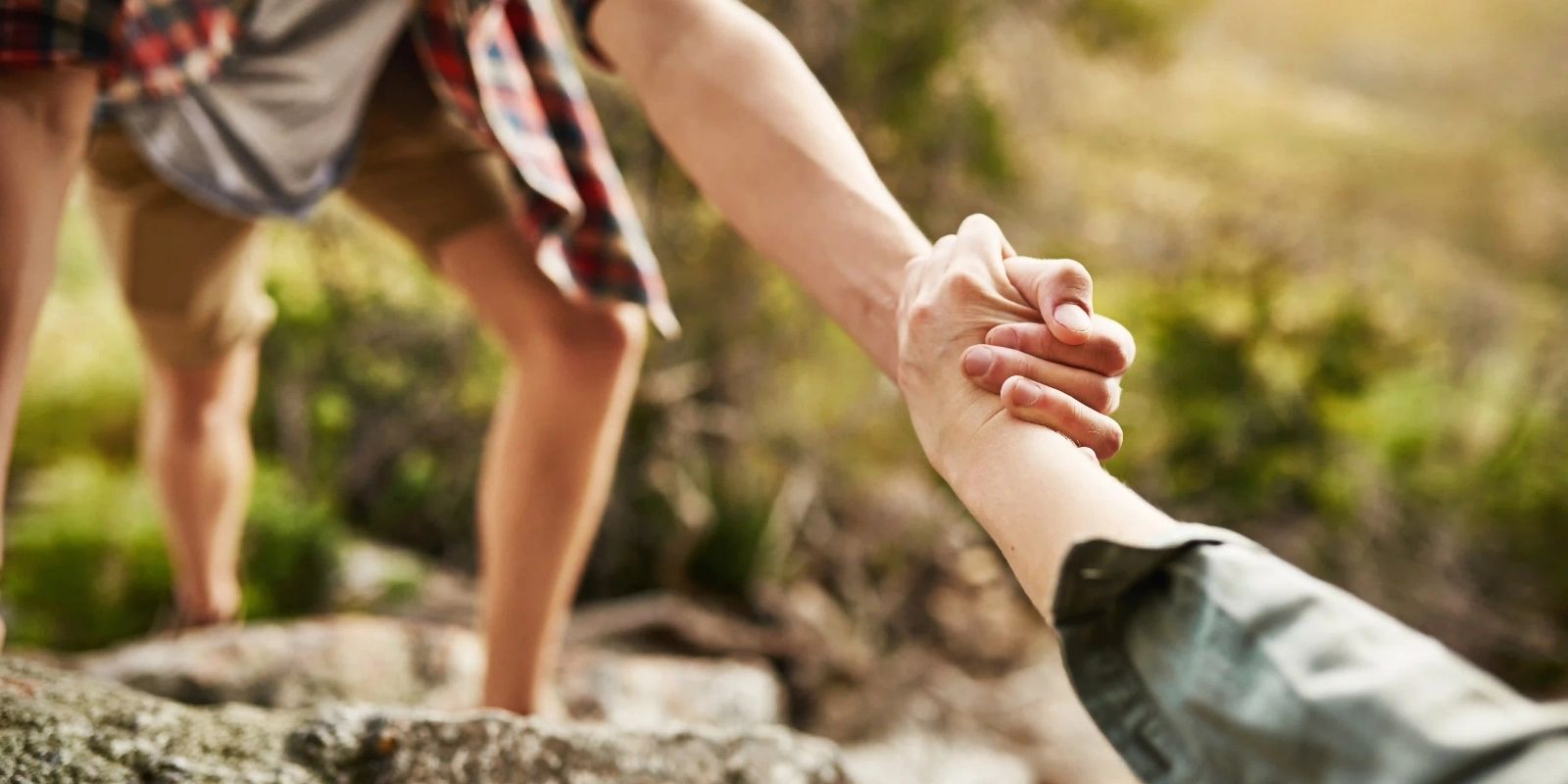 picture of a hiker helping another