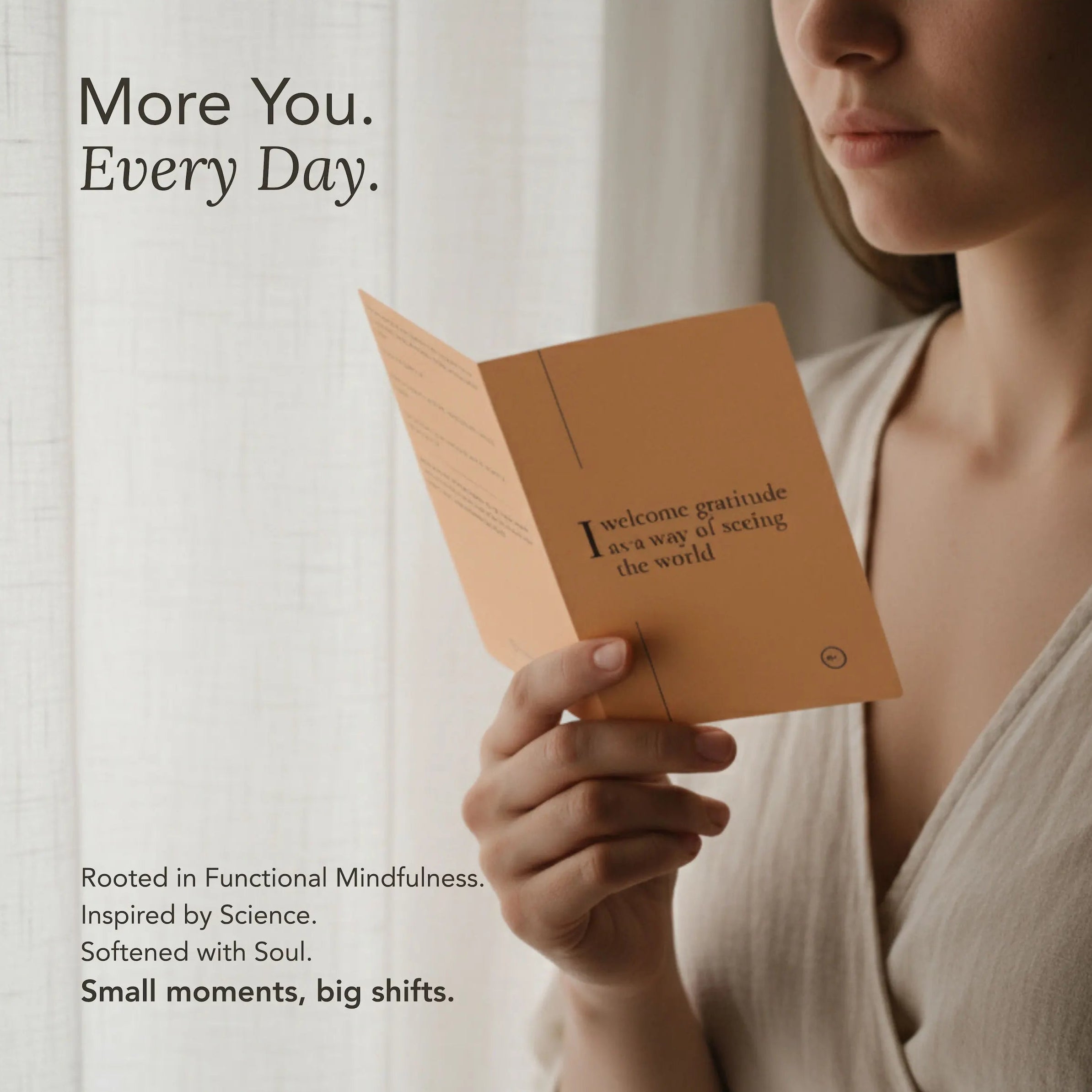 Person holding a blink card with text, with a neutral background