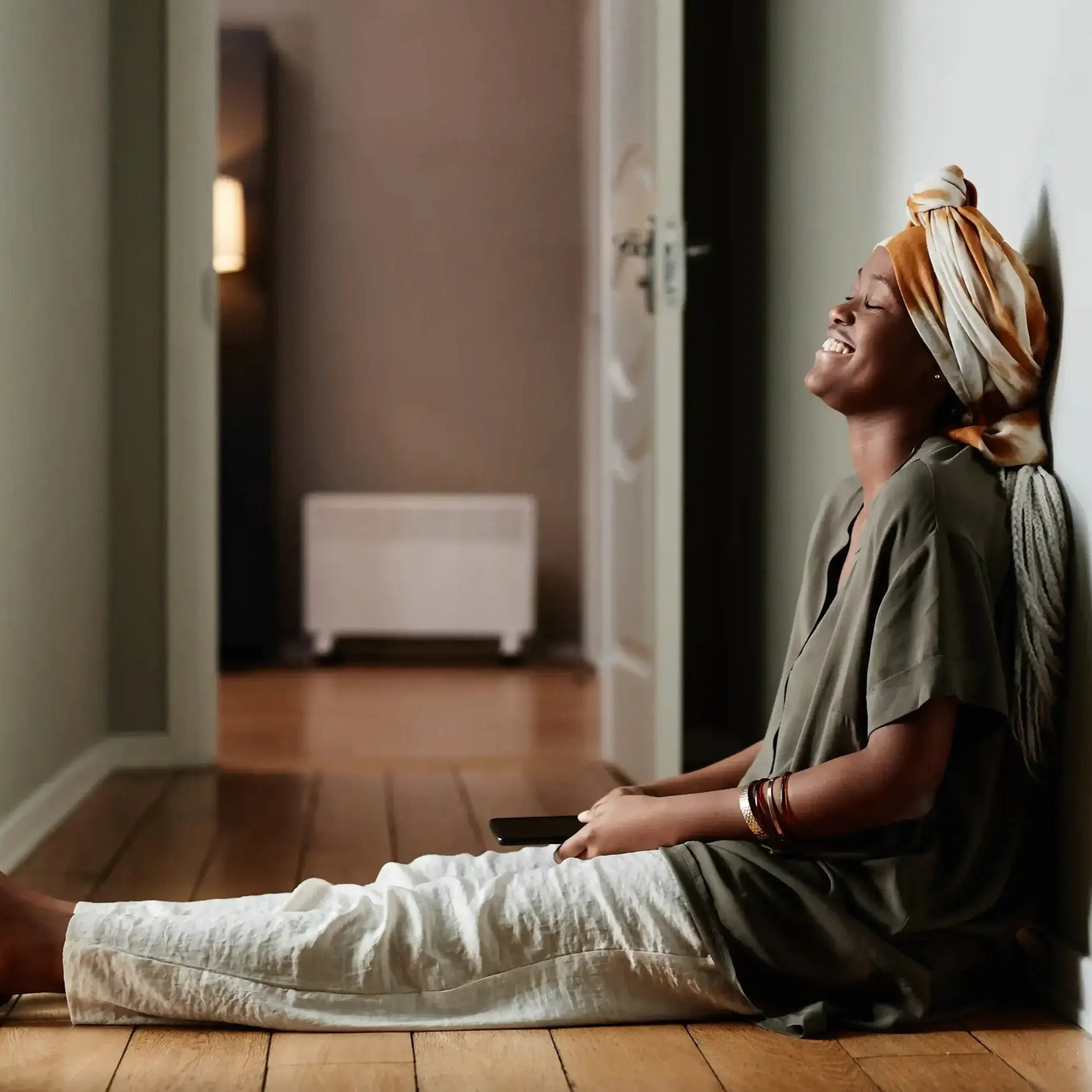 woman sitting in a hallway having a moment of clarity