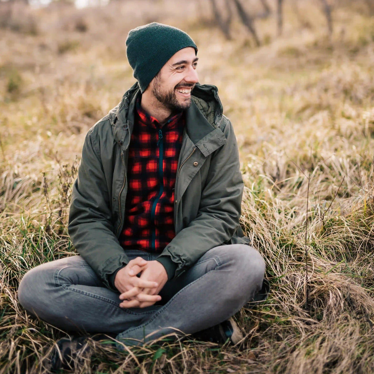 man sitting on grass in nature