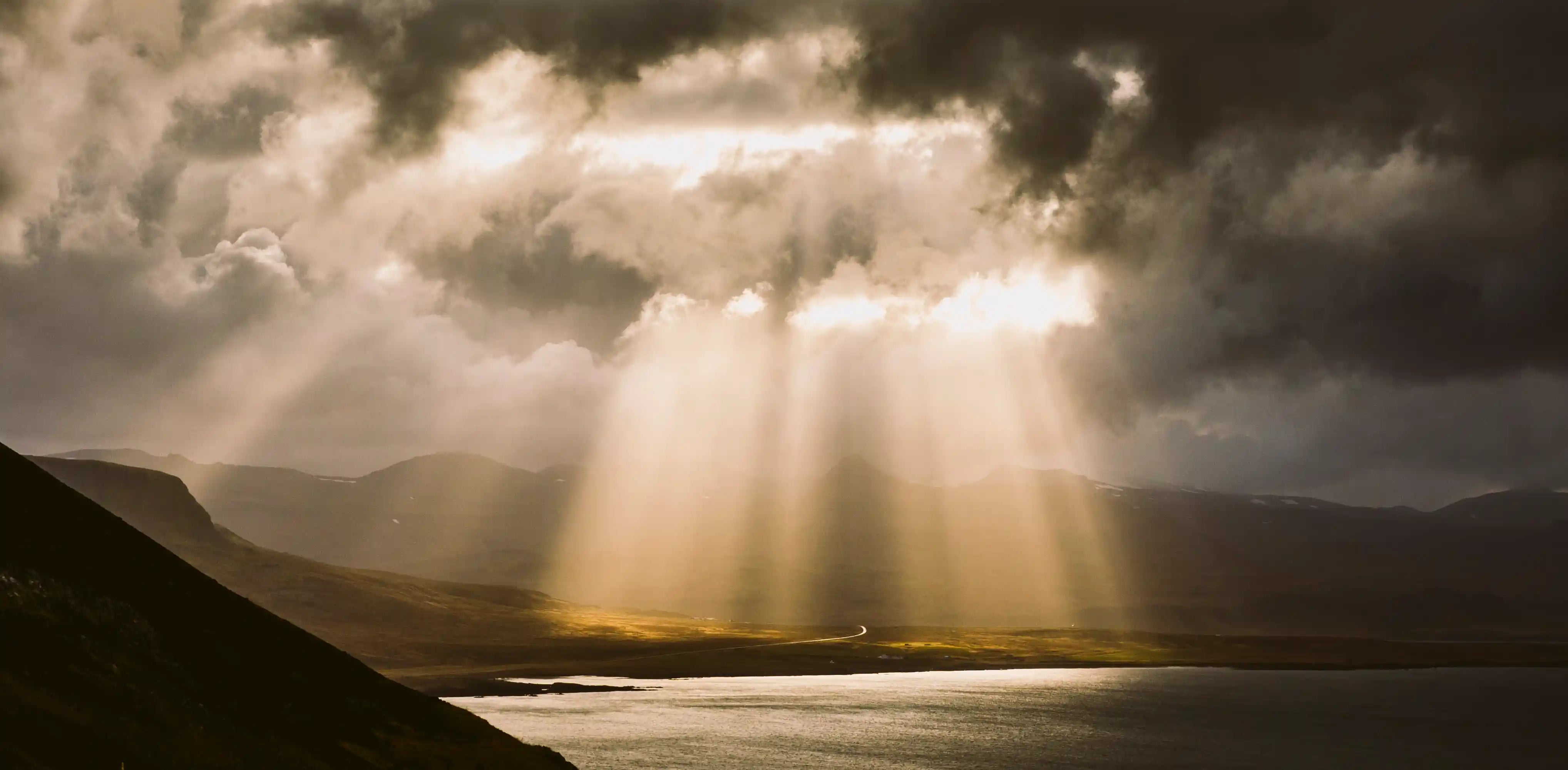 sunbeams fall among the clouds