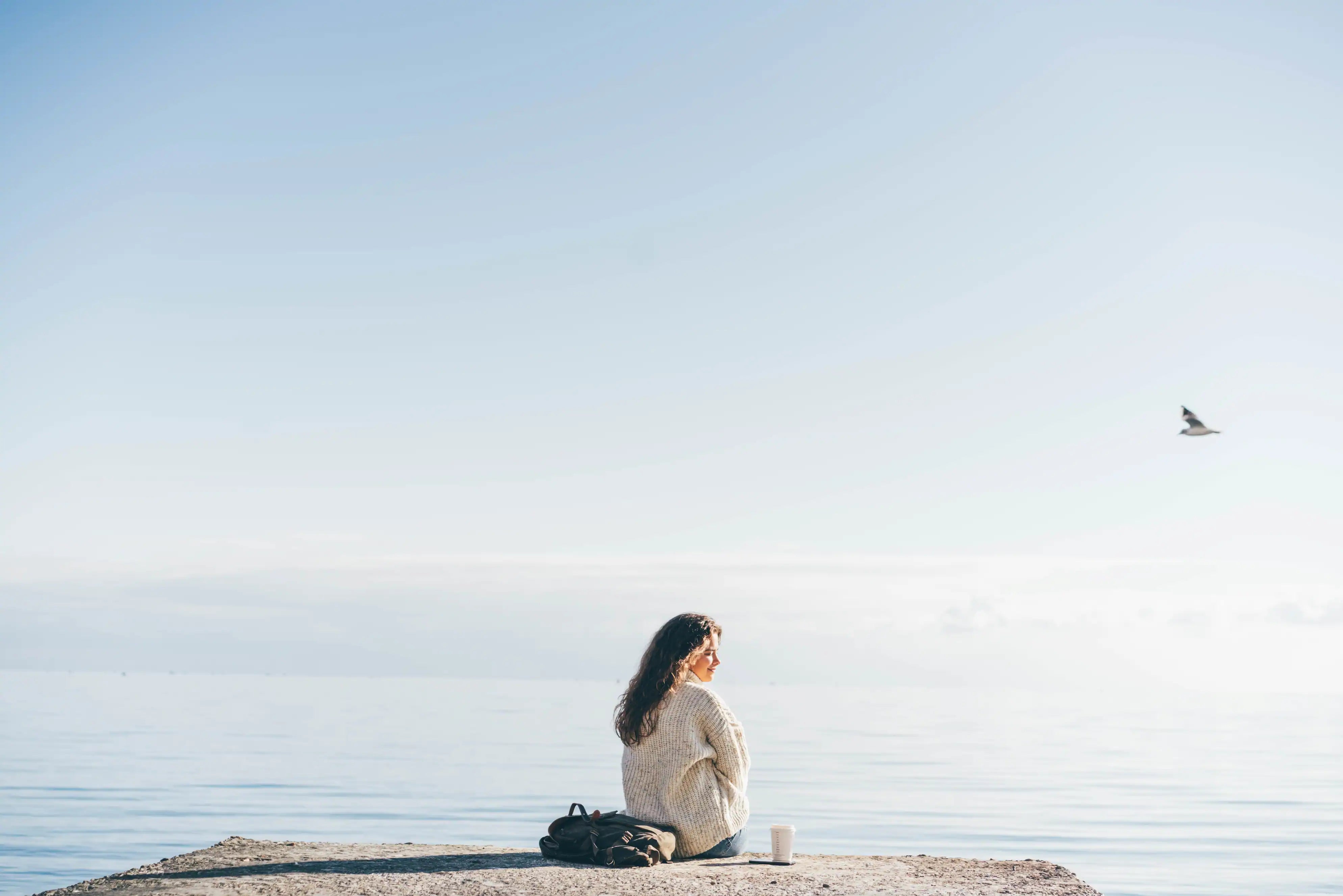 young woman sitting on the pier