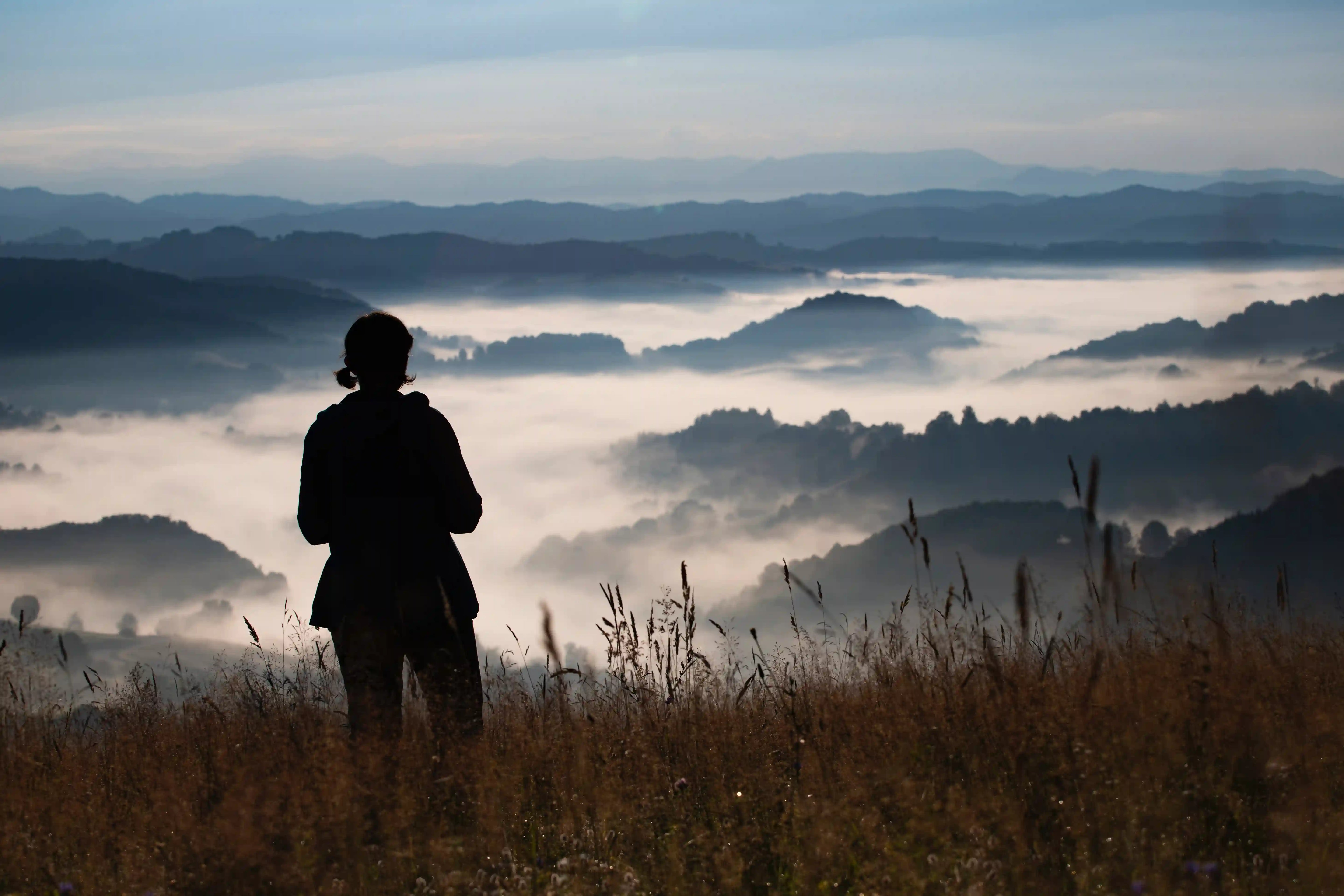 young woman standing on golden meadow