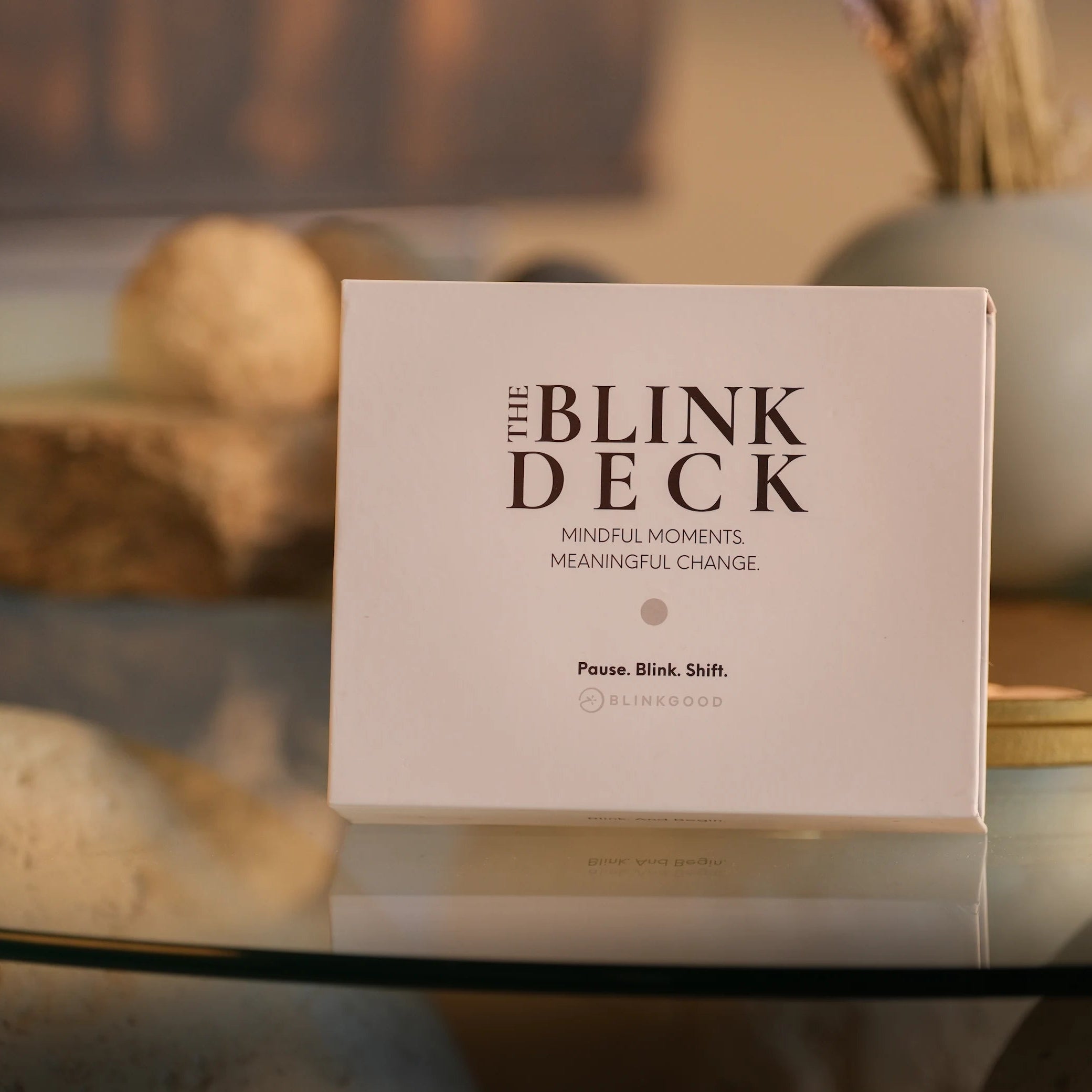 The Blink Deck packaging on a glass surface with blurred background