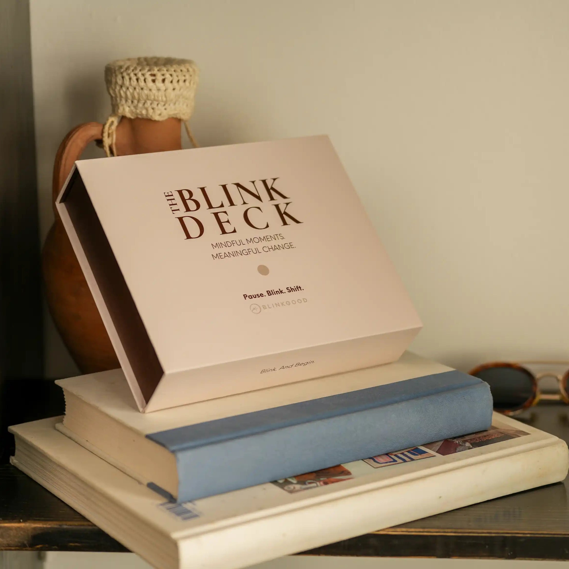 Stack of books on a shelf with 'The Blink Deck' visible