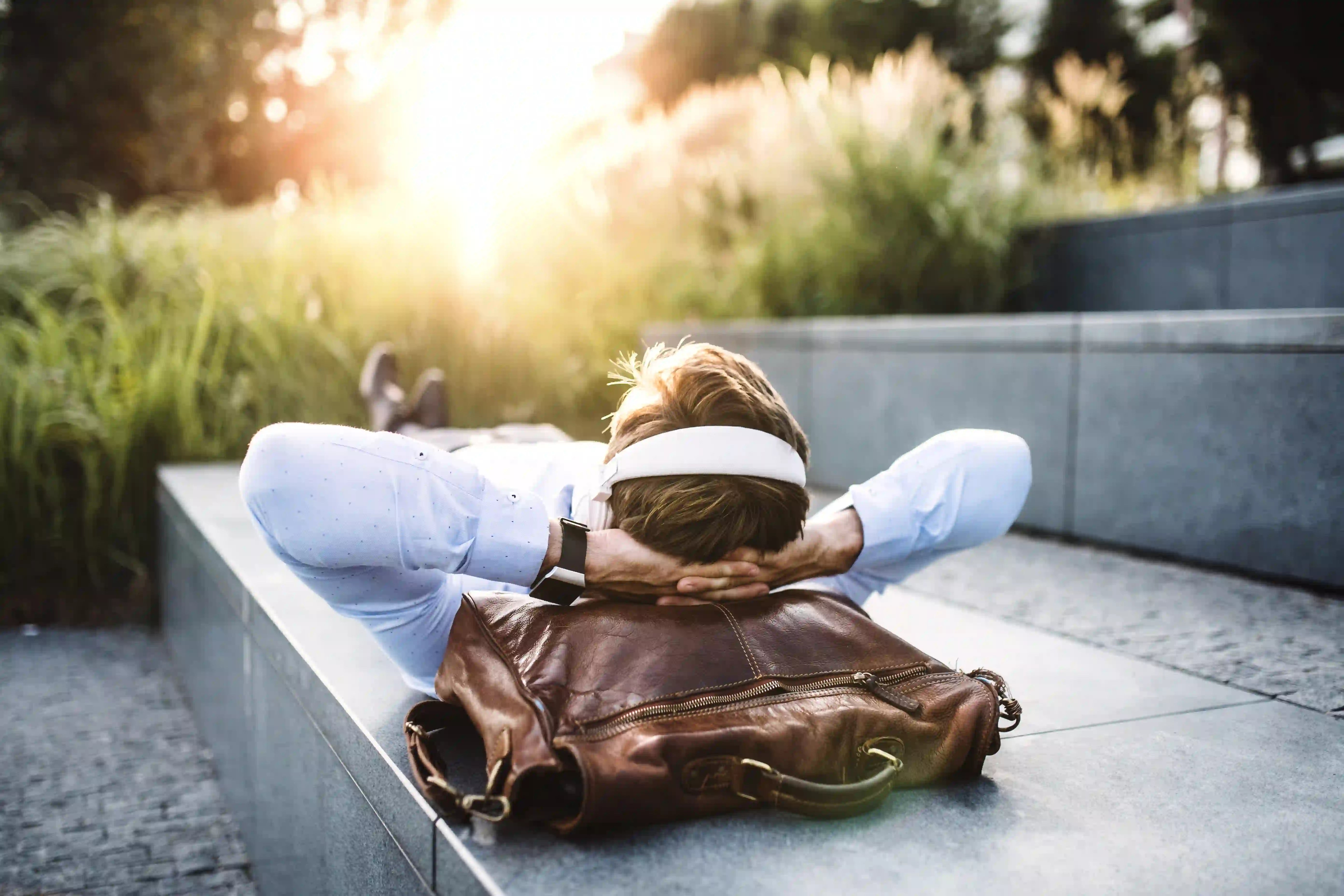 person lying on steps with headphones 